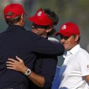 U.S. captain Davis Love III (L) congratulates Bubba Watson (C) and Webb Simpson (R) after they defeated Team Europe golfers Peter Hanson and Paul Lawrie on the 14th green during the afternoon four-ball round at the 39th Ryder Cup matches at the Medinah Country Club in Medinah, Illinois, September 28, 2012. REUTERS/Matt Sullivan