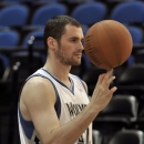 In this Oct. 1, 2012 photo, Minnesota Timberwolves NBA star basketball player Kevin Love spins a ball for the team photographer during media day in Minneapolis. Love is beginning the first season of a four-year, $60 million contract extension and says when 