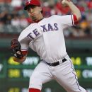 Texas Rangers starting pitcher Derek Holland throws during the first inning of the second baseball game of a doubleheader against the Los Angeles Angels, Sunday, Sept. 30, 2012, in Arlington, Texas. (AP Photo/LM Otero)
