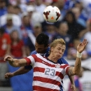 United States' Brek Shea (23) heads a ball in front of El Salvador's Xavier Garcia Orellana during the second half in the quarterfinals of the CONCACAF Gold Cup soccer tournament on Sunday, July 21, 2013, in Baltimore. The United States won 5-1. (AP Photo/Patrick Semansky)