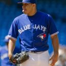 Toronto Blue Jays starting pitcher Ricky Romero rects as he faces Tampa Bay Rays' Evan Longoria during the second inning of baseball game action in Toronto, Sunday, Sept. 2 , 2012. (AP Photo/The Canadian Press, Chris Young)