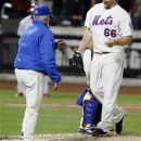 New York Mets manager Terry Collins, left, takes the ball from relief pitcher Josh Edgin after Edgin gave up a two-run home run to Philadelphia Phillies' Ryan Howard during the ninth inning of a baseball game on Wednesday, Sept. 19, 2012, in New York. (AP Photo/Frank Franklin II)