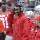 FILE - In this Sept. 21, 2013 file photo, Ohio State quarterback Braxton Miller watches from the sidelines during an NCAA college football game against Florida A&M in Columbus, Ohio. Kenny Guiton is coming off three terrific games with Miller out, but head coach Urban Meyer has said that if Miller is healthy enough and has a good week of practice, he'll be the first one to take a snap from center on Saturday night against Wisconsin. (AP Photo/Jay LaPrete, File)