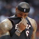 Miami Heat forward LeBron James wipes his face during the first half of an NBA basketball game against the Chicago Bulls in Chicago on Wednesday, March 27, 2013. (AP Photo/Nam Y. Huh)