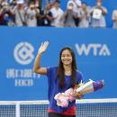 In this Tuesday, Sept. 23, 2014 photo, Chinese tennis player Li Na waves to spectators after a ceremony marking her retirement, at the Wuhan Open tennis tournament in Wuhan in central China's Hubei province. The two-time Grand Slam champion from China who took tennis in Asia to a new level, retired due to recurring knee injuries. (AP Photo)
