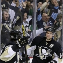 Pittsburgh Penguins left wing Chris Kunitz, right, celebrates his third goal of the game with defenseman Kris Letang (58) during the second period of an NHL hockey game against the New York Islanders in Pittsburgh Sunday, March 10, 2013. (AP Photo/Gene J. Puskar)