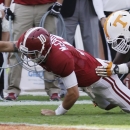 Alabama quarterback AJ McCarron (10) dives for the end zone as Tennessee defensive lineman Corey Miller (80) defends during the first half of an NCAA college football game in Tuscaloosa, Ala., Saturday, Oct. 26, 2013. McCarron was short of the goal on the play. (AP Photo/Dave Martin)
