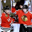 Chicago Blackhawks left wing Patrick Sharp, left, and right wing Patrick Kane celebrate Kane's goal during the third period of an NHL hockey game against the Minnesota Wild, Tuesday, March 5, 2013 in Chicago. The Blackhawks won 5-3.  (AP Photo/Brian Kersey)