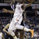 Charlotte Bobcats' Kemba Walker, front, drives past Sacramento Kings' Donte Greene during the first half of an NBA basketball game in Charlotte, N.C., Sunday, April 22, 2012. (AP Photo/Chuck Burton)