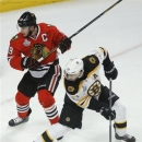 Boston Bruins center Patrice Bergeron (37) looks for a rebound against Chicago Blackhawks center Jonathan Toews (19) in the first period during Game 5 of the NHL hockey Stanley Cup Finals, Saturday, June 22, 2013, in Chicago. Bergeron left the game in the second period with an injury and did not return. (AP Photo/Charles Rex Arbogast)