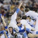UCLA players pile up after beating Mississippi State 8-0 in Game 2 of the NCAA College World Series baseball finals, Tuesday, June 25, 2013, in Omaha, Neb., winning the championship. (AP Photo/Eric Francis)