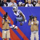 Fans watch as Dallas Cowboys wide receiver Kevin Ogletree celebrates scoring a touchdown during the second half of an NFL football game against the New York Giants, Wednesday, Sept. 5, 2012, in East Rutherford, N.J. (AP Photo/Bill Kostroun)