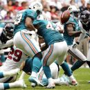 Miami Dolphins running back Daniel Thomas (33) fumbles the ball as he is hit by Houston Texans strong safety Glover Quin (29) in the second quarter of an NFL football game, Sunday, Sept. 9, 2012, in Houston. The Texans recovered the fumble. (AP Photo/Dave Einsel)