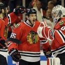 Chicago Blackhawks goalie Corey Crawford, right, celebrates with teammates Andrew Shaw, center, and Brandon Saad after they defeated the Detroit Red Wings 4-1 in Game 5 of the NHL hockey Stanley Cup playoffs Western Conference semifinals in Chicago, Saturday, May 25, 2013. (AP Photo/Nam Y. Huh)