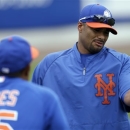 In this March 1, 2013, photo, New York Mets pitcher Johan Santana, right, talks to bullpen coach Ricky Bones (25) before the Mets' spring training baseball game against the Detroit Tigers in Port St. Lucie, Fla. The Mets say Santana has injured his left shoulder again and likely will need surgery and miss the 2013 season. (AP Photo/Julio Cortez)