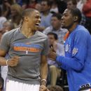 Oklahoma City Thunder guard Russell Westbrook, left, and forward Kevin Durant react after a Thunder basket during the third quarter of an NBA basketball game against the Sacramento Kings in Oklahoma City, Tuesday, April 24, 2012. Oklahoma City won 118-110. (AP Photo/Sue Ogrocki)