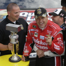 Sprint Cup Series driver Ryan Newman, right, is hugged by team owner and driver Tony Stewart after Newman won the Brickyard 400 auto race at the Indianapolis Motor Speedway in Indianapolis, Sunday, July 28, 2013. (AP Photo/Darron Cummings)