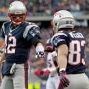 New England Patriots quarterback Tom Brady (12) fist-bumps wide receiver Wes Welker (83) after they connected for a touchdown against the Denver Broncos in the first quarter of an NFL football game, Sunday, Oct. 7, 2012, in Foxborough, Mass. (AP Photo/Steven Senne)