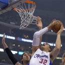 Los Angeles Clippers forward Blake Griffin, right, puts up a shot as Los Angeles Lakers forward Pau Gasol, of Spain, defends during the first half of their NBA basketball game, Friday, Jan. 4, 2013, in Los Angeles.  (AP Photo/Mark J. Terrill)