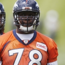 In this photo taken Wednesday, May 27, 2015, Denver Broncos offensive tackle Ryan Clady waits to take part in drills during an NFL football organized team activity at the team's headquarters in Englewood, Colo. Broncos officials announced Thursday, May 28, 2015, that Clady tore his left ACL while taking part in Wednesday's session, an injury that is likely to shelve the veteran offensive lineman for the season. (AP Photo/David Zalubowski)