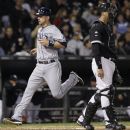 Tampa Bay Rays' Ben Zobrist, left, scores on a sacrifice fly hit by Carlos Pena as Chicago White Sox catcher A.J. Pierzynski looks to the field during the fourth inning of a baseball game in Chicago, Thursday, Sept. 27, 2012. (AP Photo/Nam Y. Huh)