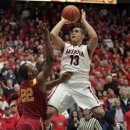 Arizona's Nick Johnson (13) shoots for two points over the attempted defense of Southern California's Byron Wesley (22) during the first half of an NCAA basketball game at McKale Center in Tucson, Ariz., Jan. 26, 2013. (AP Photo/John Miller)