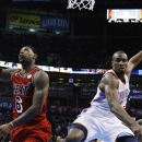 Miami Heat forward LeBron James (6) completes his shot after a foul by Oklahoma City Thunder forward Serge Ibaka (9) in the second quarter of an NBA basketball game in Oklahoma City, Thursday, Feb. 14, 2013. (AP Photo/Sue Ogrocki)