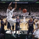 Michigan State's Adreian Payne (5) dunks as Illinois' Brandon Paul, left, Tyler Griffey (42) and Joseph Bertrand (2) and Michigan State's Denzel Valentine, right, watch during the first half of an NCAA college basketball game, Thursday, Jan. 31, 2013, in East Lansing, Mich. (AP Photo/Al Goldis)