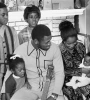 FILE - In this file photo taken Nov. 22, 1970, heavyweight champion Joe Frazier and his family pose for a family portrait after he returns from a successful defense of his boxing title in Philadelphia. While his wife Florence tries to make their youngest, Natasha, 12 weeks, Joe holds Jo-Netta. Standing behind them, from left, are Jaquelyn, 9, Marvis, 10, and Weatha, 7. The former champion died after a brief fight with liver cancer. He was 67. The family issued a release confirming the boxer's death on Monday, Nov. 7, 2011. (AP Photo, File)