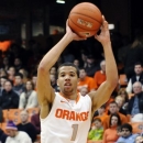 Syracuse's Michael Carter-Williams looks to pass against Central Connecticut State's Malcolm McMillan during the first half of an NCAA college basketball game in Syracuse, N.Y., Monday, Dec. 31, 2012. (AP Photo/Kevin Rivoli)