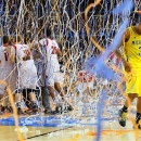 Michigan guard Trey Burke (3) walks off the court as confetti falls on Louisville players, including Russ Smith (2), Luke Hancock (11), Stephan Van Treese (44) and Zach Price (25), after the NCAA Final Four tournament college basketball championship game, Monday, April 8, 2013, in Atlanta. Louisville won 82-76. (AP Photo/Atlanta Journal-Constitution, Curtis Compton)