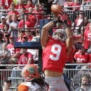 Ohio State wide receiver Devin Smith, top, catches a touchdown pass over Florida A&M cornerback Patrick Aiken during the first quarter of an NCAA college football game Saturday, Sept. 21, 2013, in Columbus, Ohio. (AP Photo/Jay LaPrete)