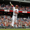 Washington Nationals' Bryce Harper celebrates as he crosses home for his solo home run during the first inning of a baseball game against the Milwaukee Brewers at Nationals Park Monday, July 1, 2013, in Washington. This is Harper's first game back after being on the disabled list. (AP Photo/Alex Brandon)