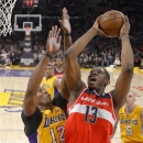 Washington Wizards forward Kevin Seraphin, right, of France, puts up a shot as Los Angeles Lakers center Dwight Howard defends during the first half of an NBA basketball game, Friday, March 22, 2013, in Los Angeles. (AP Photo/Mark J. Terrill)