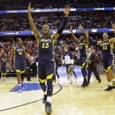 Marquette guard Vander Blue (13) celebrates with center Chris Otule (42), Jamil Wilson (0) and guard Trent Lockett (22) after their 71-61 win over Miami in an East Regional semifinal in the NCAA college basketball tournament, Thursday, March 28, 2013, in Washington. Blue scored 14 points, and Wilson led all scorers with 16 points. (AP Photo/Alex Brandon)