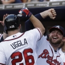 Atlanta Braves second baseman Dan Uggla (26) celebrates with Brian McCann, right, after hitting a three-run home run in the first inning of a baseball game against the Minnesota Twins Monday, May 20, 2013, in Atlanta. (AP Photo/John Bazemore)