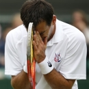 Ivan Dodig of Croatia reacts as he plays Denis Kudla of United States during their Men's second round singles match at the All England Lawn Tennis Championships in Wimbledon, London, Thursday, June 27, 2013. (AP Photo/Sang Tan)
