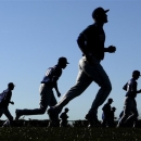 Texas Rangers players run during a spring training baseball workout, Thursday, Feb. 14, 2013, in Surprise, Ariz. (AP Photo/Charlie Riedel)