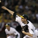 Oakland Athletics pitcher Jarrod Parker delivers a pitch in the first inning of Game 5 of an American League division baseball series against the Detroit Tigers in Oakland, Calif., Thursday, Oct. 11, 2012. (AP Photo/Ben Margot)
