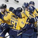 Nashville Predators forward Alexander Radulov (47), right, of Russia, celebrates with teammates including Francis Bouillon (51), Gabriel Bourque (57), and David Legwand (11) after scoring against the Detroit Red Wings in the first period of Game 5 of a first-round NHL hockey playoff series on Friday, April 20, 2012, in Nashville, Tenn. (AP Photo/Mark Humphrey)