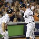 New York Yankees' Nick Swisher, right, celebrates his grand slam with Mark Teixeira during the third inning of the baseball game against the Texas Rangers Monday, Aug. 13, 2012 at Yankee Stadium in New York.  (AP Photo/Seth Wenig)