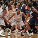 Providence guard Kris Dunn (3) and forward Kadeem Batts (10) defend against Connecticut guard Ryan Boatright (11) during the first half of an NCAA college basketball game, Thursday, Jan. 31, 2013, in Providence, R.I. (AP Photo/Stew Milne)