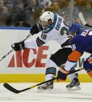San Jose Sharks ' Logan Couture (39) battles for the puck with New York Islanders ' Marty Reasoner (16) during the first period of an NHL hockey game on Saturday, Oct. 29, 2011, in Uniondale, N.Y. Couture scored during the Sharks 3-2 win.