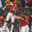 Texas Tech's Jakeem Grant (11) celebrates with Blake Dees, right, after returning a kickoff for a touchdown against Minnesota during the first quarter of the Meineke Car Care Bowl NCAA college football game, Friday, Dec. 28, 2012, in Houston. (AP Photo/Dave Einsel)