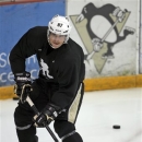 Pittsburgh Penguins captain Sidney Crosby, wearing a sweater with a National Hockey Players' Association logo on it, skates past a Penguins hockey team logo as he takes part in an informal workout at the Iceoplex in Canonsburg, Pa., on Thursday, Oct. 11, 2012, a day that the NHL would've opened the regular season if it weren't for the current lockout. (AP Photo/Keith Srakocic)