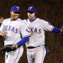 Texas Rangers center fielder Craig Gentry , right, celebrates with right fielder Nelson Cruz the Rangers' 4-2 win over the Chicago Cubs after a interleague baseball game, Tuesday, April 16 2013, in Chicago. (AP Photo/Charles Rex Arbogast)