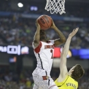 Louisville guard Russ Smith (2) shoots over Michigan guard Nik Stauskas (11) during the first half of the NCAA Final Four tournament college basketball championship game Monday, April 8, 2013, in Atlanta. (AP Photo/Charlie Neibergall)