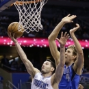 FILE - In this Jan. 20, 2013 file photo,Orlando Magic's J.J. Redick (7) shoots in front of Dallas Mavericks' Dirk Nowitzki, of Germany, during the second half of an NBA basketball game in Orlando, Fla. A person familiar with the situation says the Orlando Magic have agreed to trade veteran shooting guard Redick, center Gustavo Ayon and reserve point guard Ish Smith to the Milwaukee Bucks in exchange for guards Doron Lamb and Beno Udrih, as well as forward Tobias Harris. The person spoke to The Associated Press Thursday, Feb. 21, 2013 on condition of anonymity because the deal was not officially complete. (AP Photo/John Raoux, File)