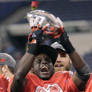 Wisconsin running back Montee Ball holds up the trophy after Wisconsin defeated Nebraska 70-31 to win the Big Ten championship NCAA college football game Saturday, Dec. 1, 2012, in Indianapolis. (AP Photo/AJ Mast)