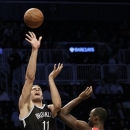 Brooklyn Nets' Brook Lopez (11) shoots over Washington Wizards center Emeka Okafor (50) during the first half of their NBA preseason basketball game at the Barclays Center in New York, Monday, Oct. 15, 2012. (AP Photo/Kathy Willens)